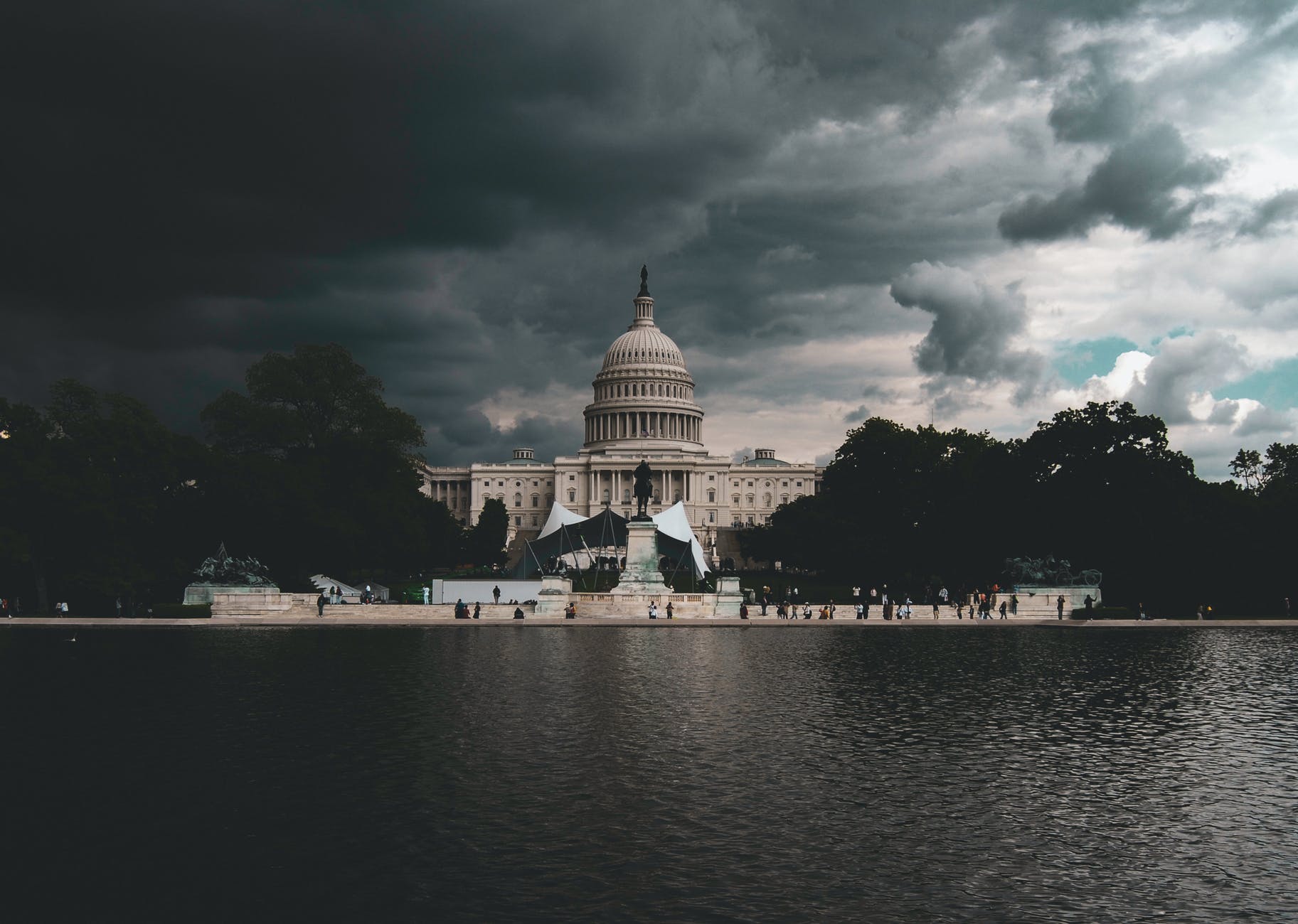 dome building near body of water under cloudy sky