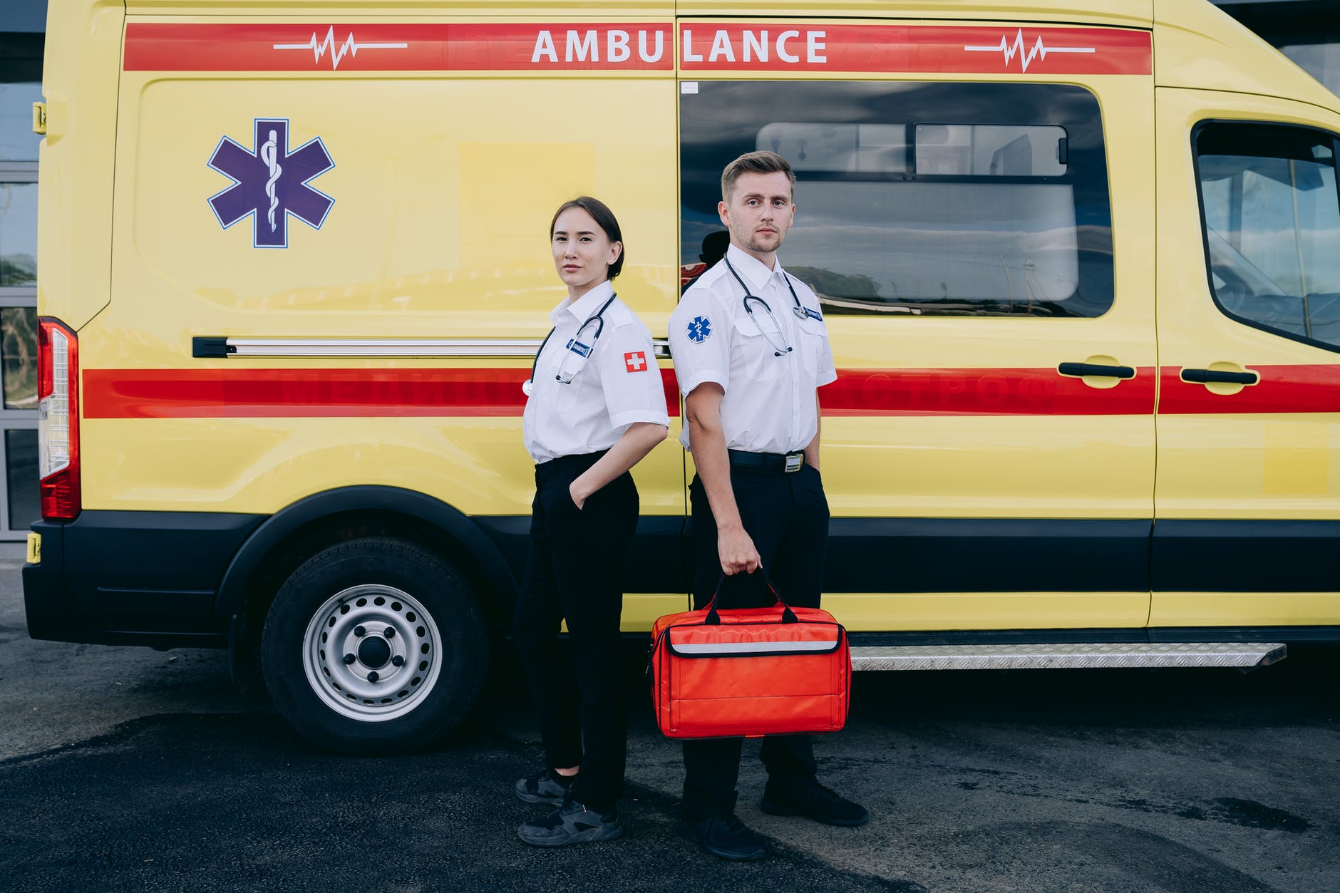 paramedics standing beside an ambulance